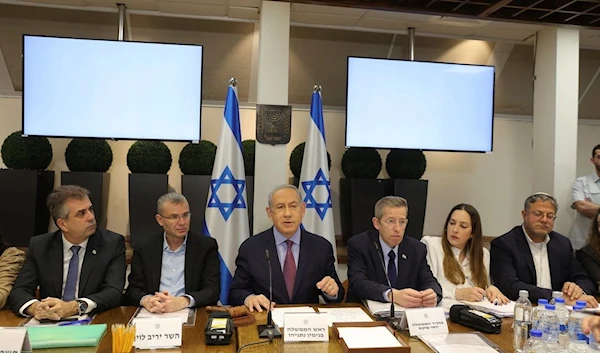 Israeli Prime Minister Benjamin Netanyahu, center, attends the weekly cabinet meeting at the "Kirya" military base in "Tel Aviv", Occupied Palestine Sunday, Dec. 31, 2023 (AP)