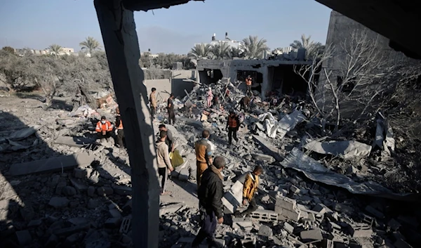 Palestinians inspect the damage of a destroyed house following Israeli airstrikes on Khan Younis, Southern Gaza Strip, Sunday, Dec. 31, 2023. (AP)