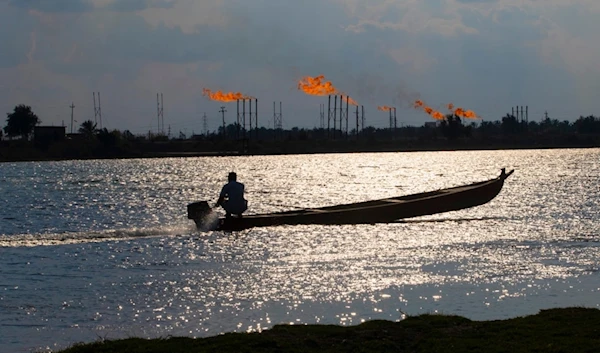 A man near the Nihran Bin Omar oil field north of Basra, Iraq, Wednesday, March 22, 2023. (AP)