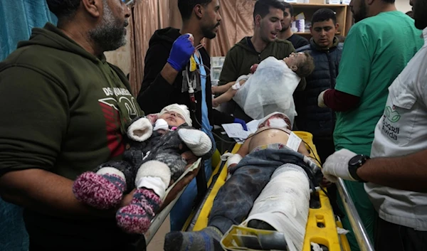 Palestinian children wounded in the Israeli bombardment of the Gaza Strip are brought to the hospital in Deir al Balah, Gaza Strip, occupied Palestine, on Monday, Dec. 11, 2023. (AP)