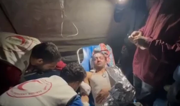 Palestine Red Crescent Society treating Palestinians in torchlight