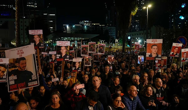 Families and supporters of Israeli hostages held by Hamas in Gaza hold their photos and shout slogans during a rally calling for their release, in 'Tel Aviv', 'Israel', Saturday, Dec. 30, 2023.(AP)