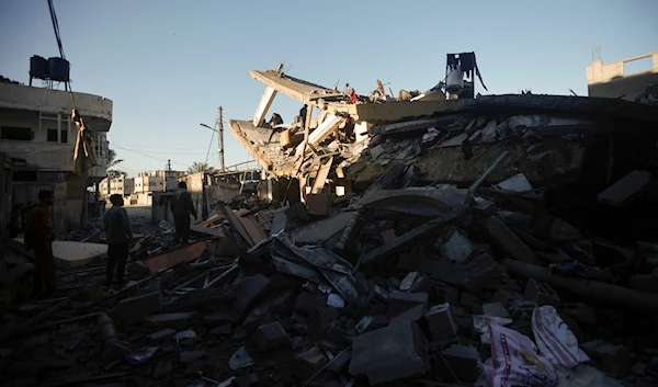 Palestinians inspect the damage of a destroyed house following Israeli airstrikes on Khan Younis, Southern Gaza Strip, Sunday, Jan. 7, 2024. (AP)