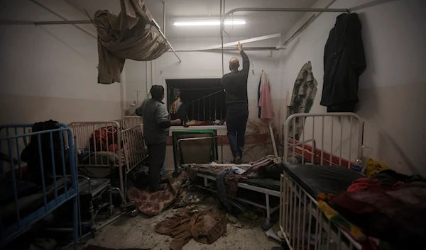 Palestinian paramedics inspect damage in the patient rooms caused by the Israeli strikes on the maternity ward at Nasser Hospital in the town of Khan Younis, southern Gaza Strip, Sunday, Dec. 17, 2023.