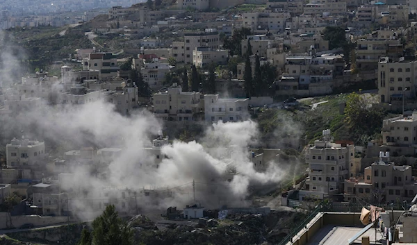 Smoke rises as Israeli security forces demolish the home of two Hamas militants in the Palestinian east al-Quds neighborhood of Sur Baher, on Tuesday, Jan. 9, 2024. (AP)