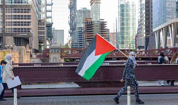 Protesters walk away from Accenture Tower after a rally that was held in solidarity with Palestinians, in Chicago on Wednesday, May 12, 2021. (AP)