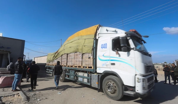 Humanitarian aid trucks enter the Gaza Strip from the occupied territories through the "Kerem Shalom" crossing in Rafah on Sunday, Jan. 14, 2024. (AP Photo/Hatem Ali)