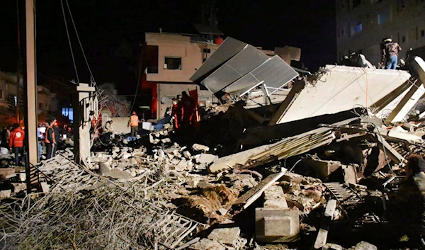 In this photo released by the Syrian official news agency SANA, Syrian security forces and civil defence workers gather next of a building that was destroyed by Israeli airstrikes, in Homs, Syria, late Tuesday, Feb. 6, 2024. (AP)