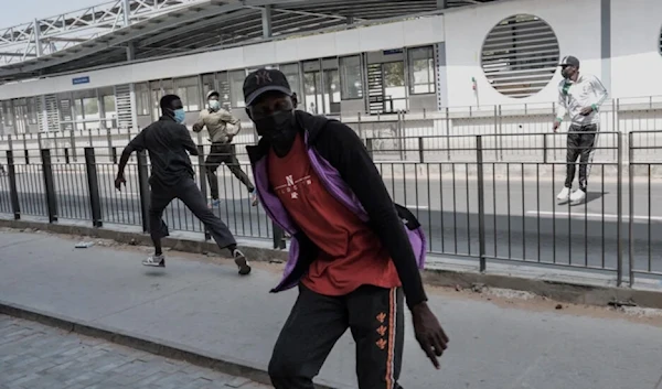 Protestors react during clashes with police in Dakar on February 9, 2024. (AFP)