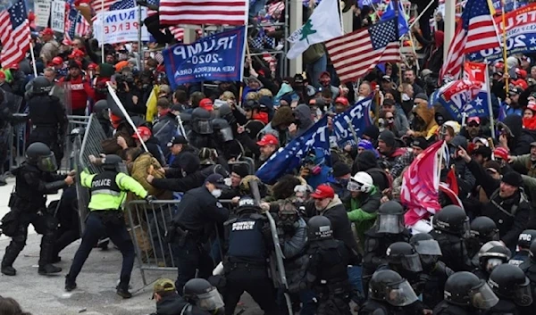 Trump supporters clash with US police and security forces as they push barricades to storm the US capitol, on January 6, 2021. (AFP)