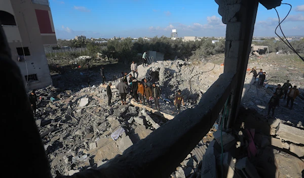 Palestinians search for survivors after an Israeli airstrike on a residential building In Rafah, Gaza Strip, occupied Palestine, February 10, 2024 (AP)