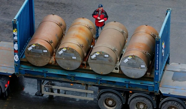 A truck carries containers with low-enriched uranium to be used as fuel for nuclear reactors, on a port in St. Petersburg, Russia, Thursday, Nov. 14, 2013. (AP)