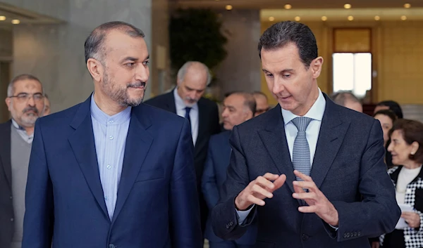 In this photo released by the Syrian official news agency SANA, Syrian President Bashar Assad, right, speaks with Iran's Foreign Minister Hossein Amir-Abdollahian, March 23, 2022, in Damascus, Syria (AP)