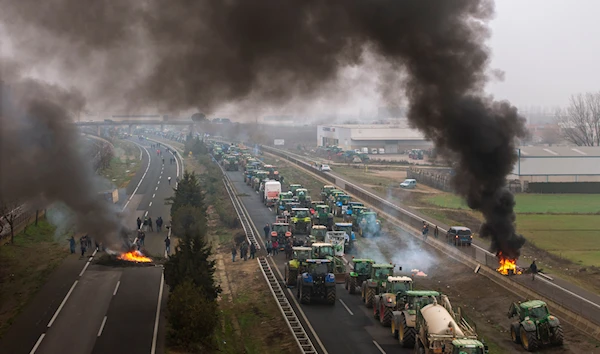 Farmers make barricades after blocking a highway during a protest near Mollerussa, northeast Spain, Tuesday, Feb. 6, 2024. (AP)