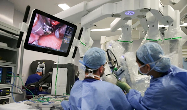 Lead surgeon Vin Paleri conducts a robotic assisted tongue base hemiglossectomy surgery on a patient during his visit to the Royal Marsden NHS Foundation Trust in London, Jan. 10, 2018. (AP)