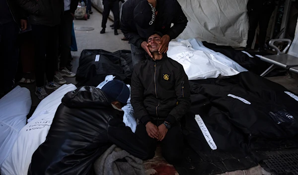 Palestinians mourn relatives killed in the Israeli bombardment of the Gaza Strip at a hospital morgue in Rafah, Monday, Feb. 12, 2024. (AP)