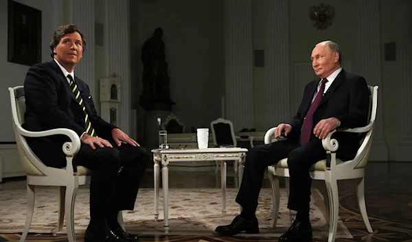 Released by Sputnik on Feb. 9, 2024, Russian President Vladimir Putin and former Fox News host Tucker Carlson prepare to an interview at the Kremlin in Moscow, Russia, Tuesday, Feb. 6, 2024. (AP)