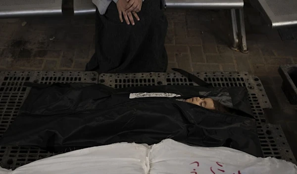 A Palestinian mother mourns next to her child's body outside a morgue in Rafah on February 4, 2024. (AP)