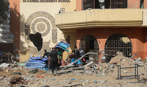 Palestinians collect their belongings from a school in Gaza City on Friday, Nov. 24, 2023(AP)