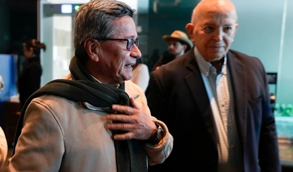 Pablo Beltran, left, commander and chief negotiator for the ELN and Jose Otty Patiño, chief negotiator for the Colombian government, arrive for a press conference as a part of peace talks in Bogota, Colombia, Tuesday, Oct. 10, 2023. (AP)