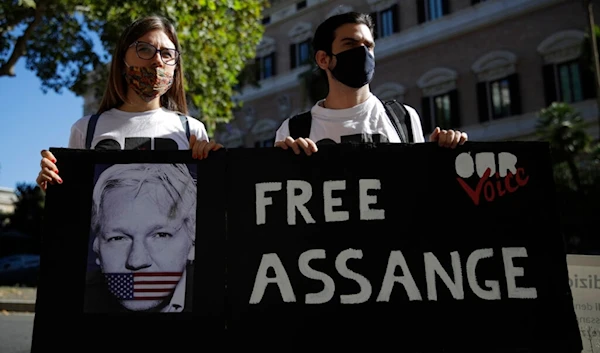 Protestors hold a placard reading Free Assange outside the United States Embassy in Rome, Monday, Sept. 7, 2020 (AP Photo/Alessandra Tarantino)