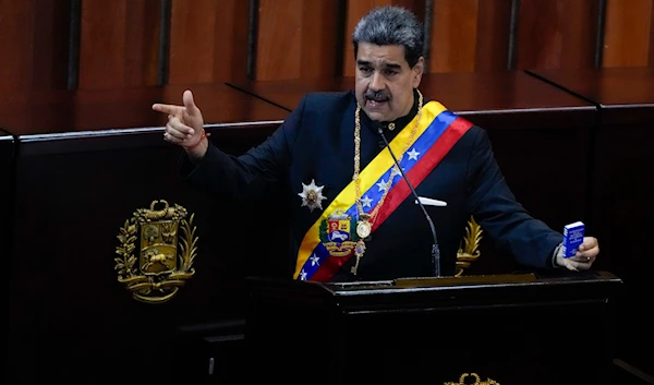 Venezuelan President Nicolas Maduro holds a small copy of his nation's constitution during a ceremony marking the start of the judicial year at the Supreme Court in Caracas, Venezuela, Wednesday, Jan. 31, 2024(AP)