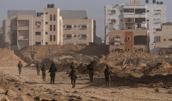 Israeli occupation forces walk during a ground operation in Khan Younis, Gaza Strip on Wednesday, Jan. 10. 2024(AP)