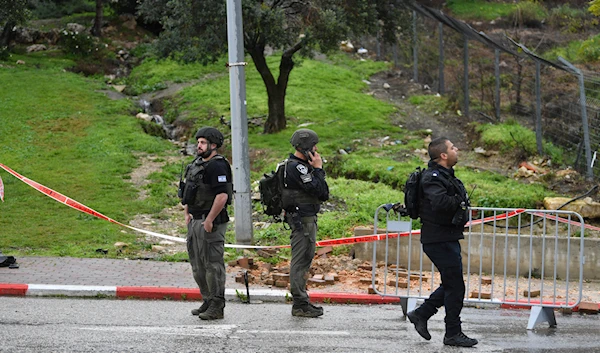 Israeli occupation forces examine the site hit by a rocket fired from Lebanon, in Safed, northern occupied Palestine, Wednesday, February 14, 2024 (AP)