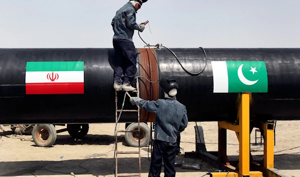 In this March 11, 2013 file photo, Iranian workers weld two gas pipes together at the start of construction on a pipeline to transfer natural gas from Iran to Pakistan, in Chabahar, southeastern Iran, near the Pakistani border. (AP)