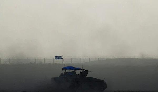 Israeli armored vehicle moves near the "borders" with Gaza, as seen from southern Palestine, Thursday, Feb. 15, 2024. (AP Photo/Leo Correa)