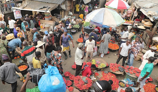 Pedestrians shop for pepper and other food items at the Mile 12 Market in Lagos, Nigeria, Friday, Feb. 16, 2024. (AP)