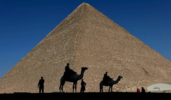 Policemen are silhouetted against the Great Pyramid in Giza, Egypt, Dec 12, 2012. (AP)