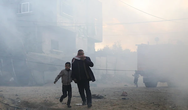 Palestinians run away after an Israeli strike on a residential building in Rafah, Monday, Feb. 19, 2024. (AP)