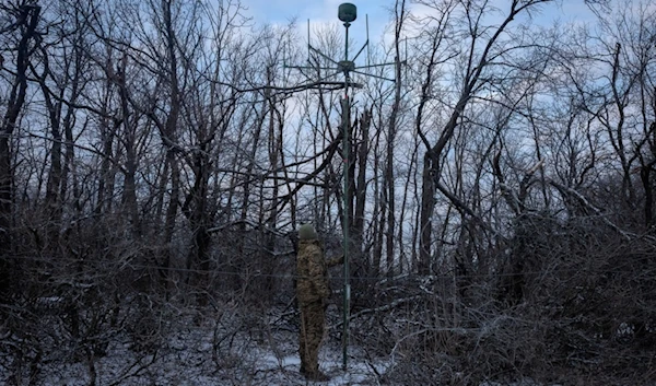 A Ukrainian soldier installs an electronic warfare system antenna to listen to Russian chatter at the front line near Bakhmut, Donetsk region, Ukraine, Monday, Jan. 29, 2024. (AP)