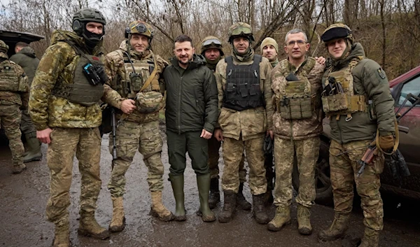 Ukrainian President Volodymyr Zelenskyy, center, poses for a photo with servicemen during his visit to Zaporizhzhia region, the site of fierce battles with the Russian troops, in Ukraine, Sunday, Feb. 4, 2024. (AP)