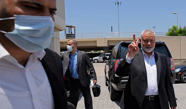 Ismail Haniyeh, head of Hamas's political bureau, flashes the victory sign upon his arrival at Rafik Hariri International Airport, in Beirut, Lebanon, Sunday, June 27, 2021(AP)