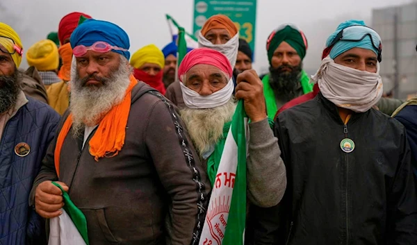 Indian farmers who have been protesting for a week to demand guaranteed crop prices wait to march to the capital near Shambhu border that divides northern Punjab and Haryana states, India, Wednesday, Feb.21, 2024.(AP)