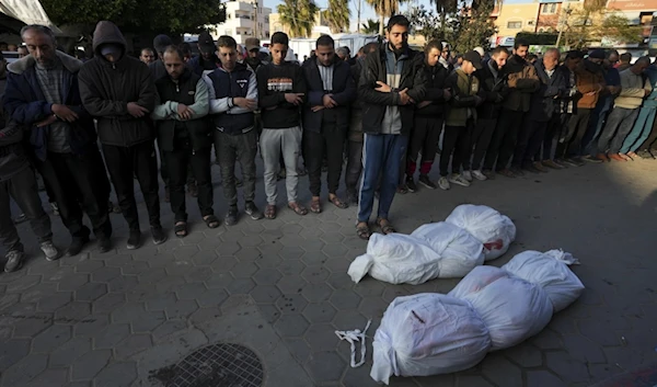 Palestinians pray for the relatives killed in the Israeli bombing in the Gaza Strip at al-Aqsa Hospital in Deir al Balah, Gaza strip, on Saturday, February 17, 2024. (AP)