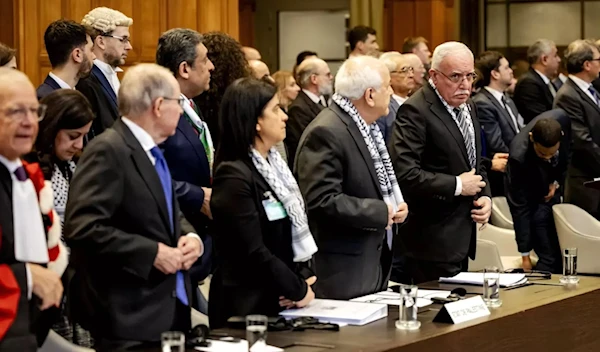 Minister of Foreign Affairs of the Palestinian Authority Riyad al-Maliki (R) stands with colleagues at the International Court of Justice (ICJ) in The Hague, 19 February 2024 (AFP)