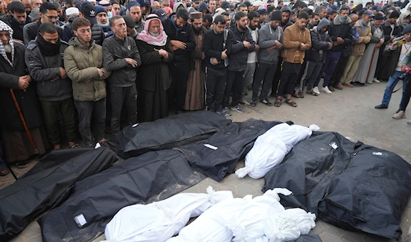 Palestinians pray over the bodies of their relatives martyred in the Israeli bombardments of the Gaza Strip in front of the morgue to pray over them at al-Aqsa Hospital in Deir al-Balah on Friday, Feb. 23, 2024. (AP)