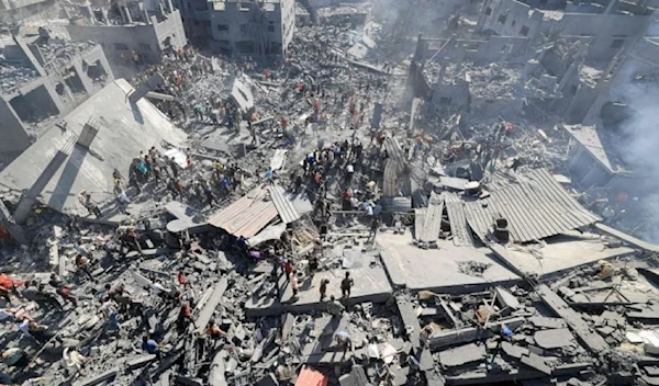 People search for survivors and the bodies of victims through the rubble of buildings destroyed during Israeli air strike, in Khan Younis in the southern Gaza Strip, Oct. 26, 2023. (AFP via Getty Images)