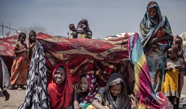 Sudanese girls and women find some shade at a transit center for refugees in Renk, South Sudan. (AFP)