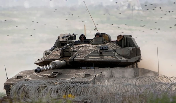 Israeli occupation soldiers drive a tank on the "border" with the Gaza Strip, in southern Palestine, Tuesday, Feb. 13, 2024. (AP)