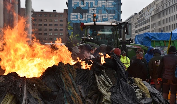 Protestors light fires during a farmers demonstration in the European Quarter outside a meeting of EU agriculture ministers in Brussels, Monday, Feb. 26, 2024. (AP)