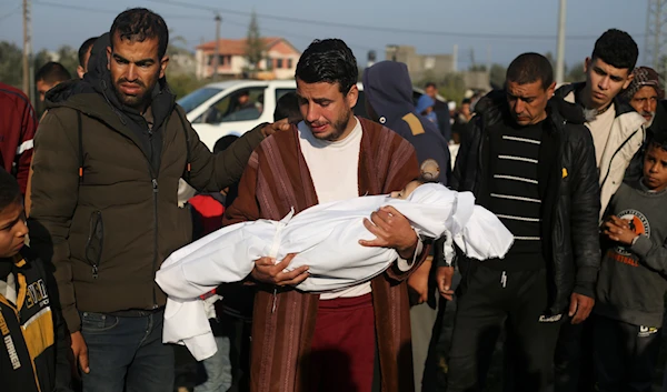 Palestinian Abdul Rahman Sharif holds the body of his four-year-old son Abdul Rahman Muamm, martyred by the Israeli bombardment of the Gaza Strip, during his funeral in Khan Younis, Monday, Feb. 26, 2024. (AP)