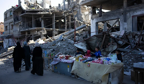 Palestinians sell goods next to buildings destroyed by an Israeli airstrike in Rafah, Gaza Strip, Wednesday, Feb. 21, 2024.(AP)