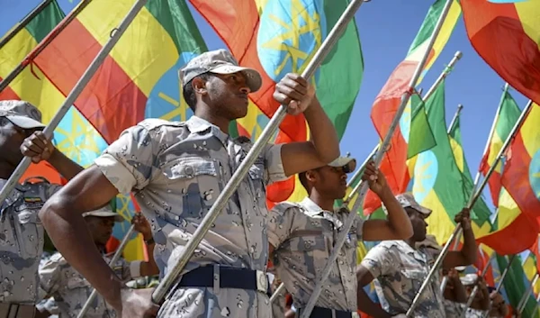 Members of the Ethiopian National Defense Force hold national flags (AP)