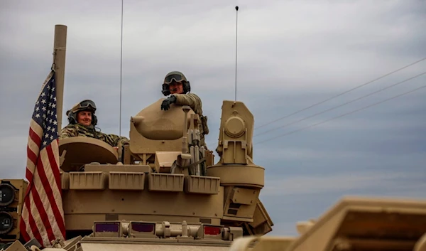 American soldiers sit in a fighting vehicle near prison that was attacked by the Islamic Stete militants in Hassakeh, Syria, Tuesday, Feb. 8, 2022. (AP Photo/Baderkhan Ahmad)