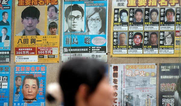 A wanted poster, center top, for Satoshi Kirishima, a fugitive who has long been wanted for one of a series of bombings in Japan, is displayed outside a Police station Friday, Feb. 2, 2024, in Tokyo(AP)