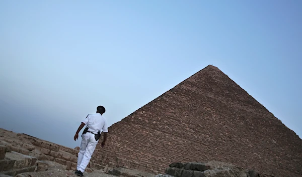 An Egyptian policeman walks near a pyramid in Giza, Egypt, on Nov. 9, 2015. (AP)